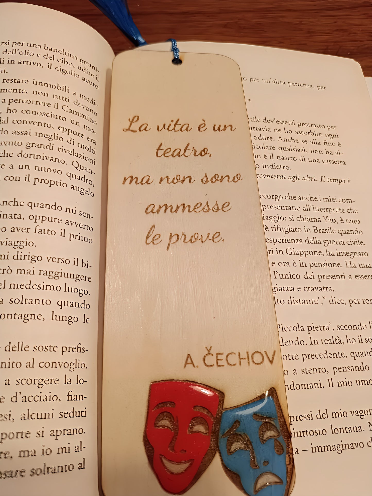 Italian book open with a wooden bookmark featuring theatrical masks and Chekhov quote