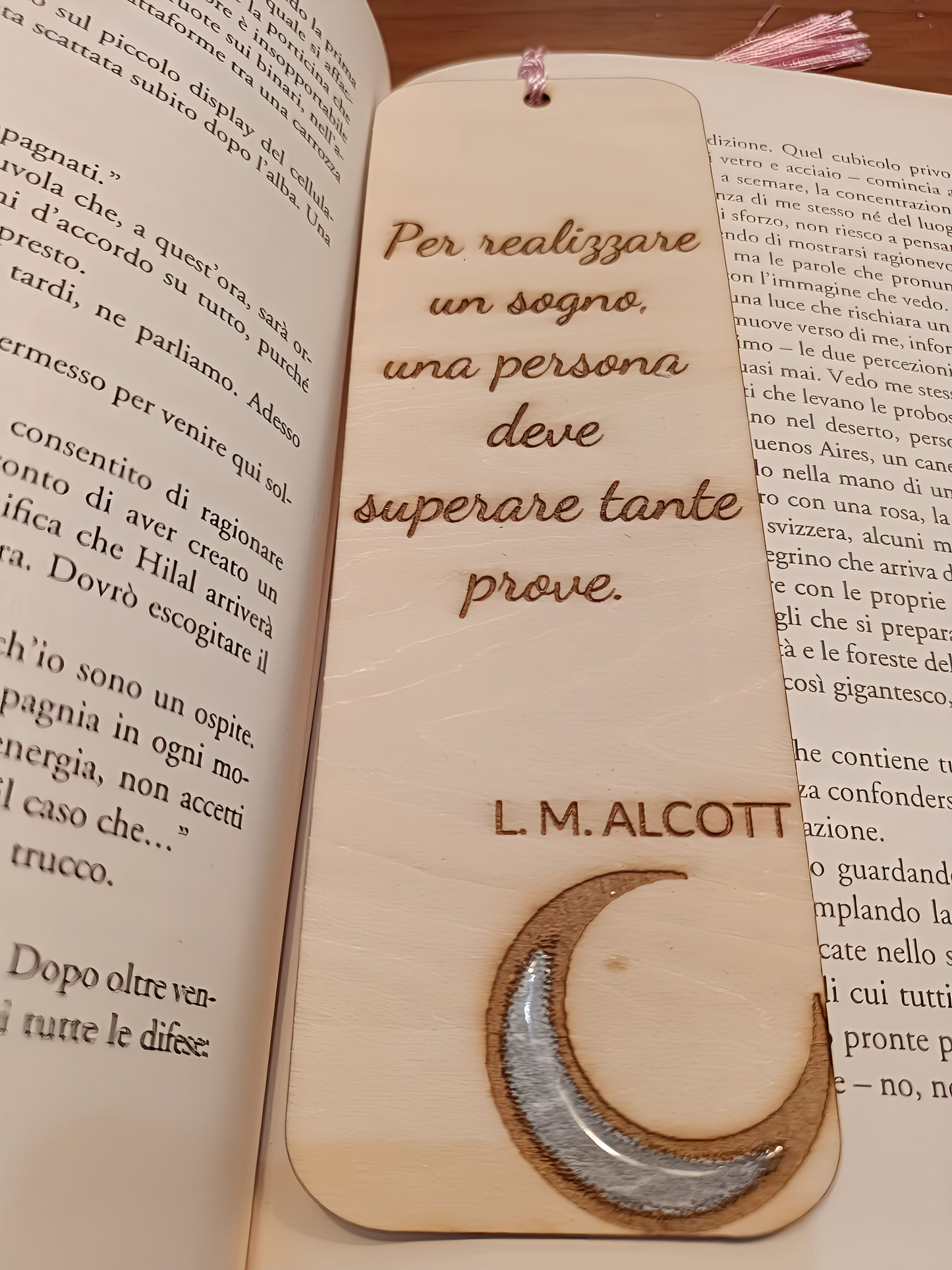 Wooden bookmark with Italian quote and crescent moon on open book pages, L.M. Alcott engraved.
