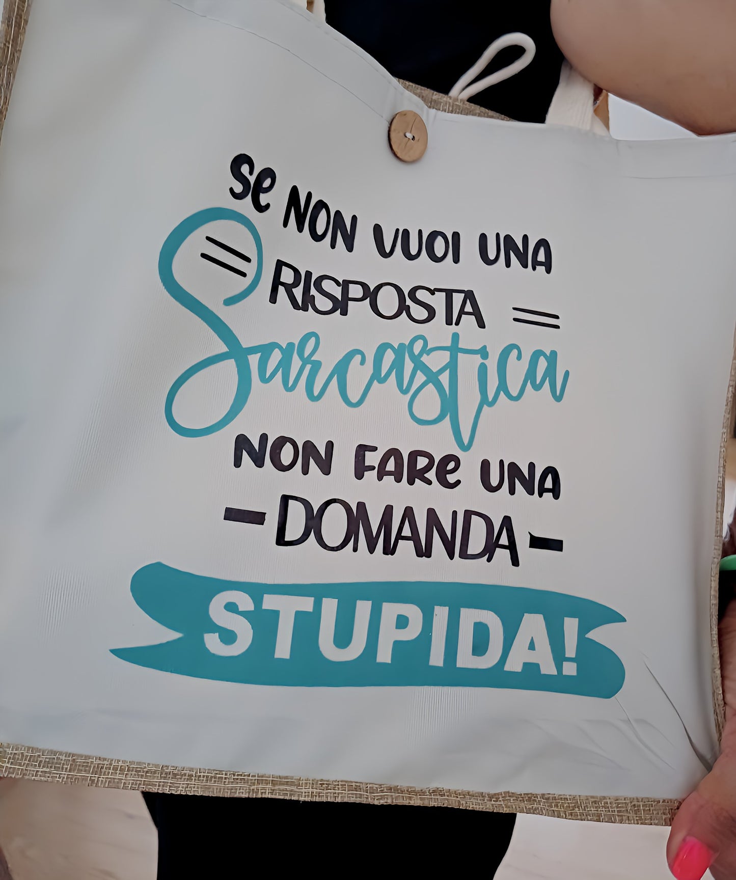 White tote bag with Italian sarcastic quote printed in black and turquoise lettering