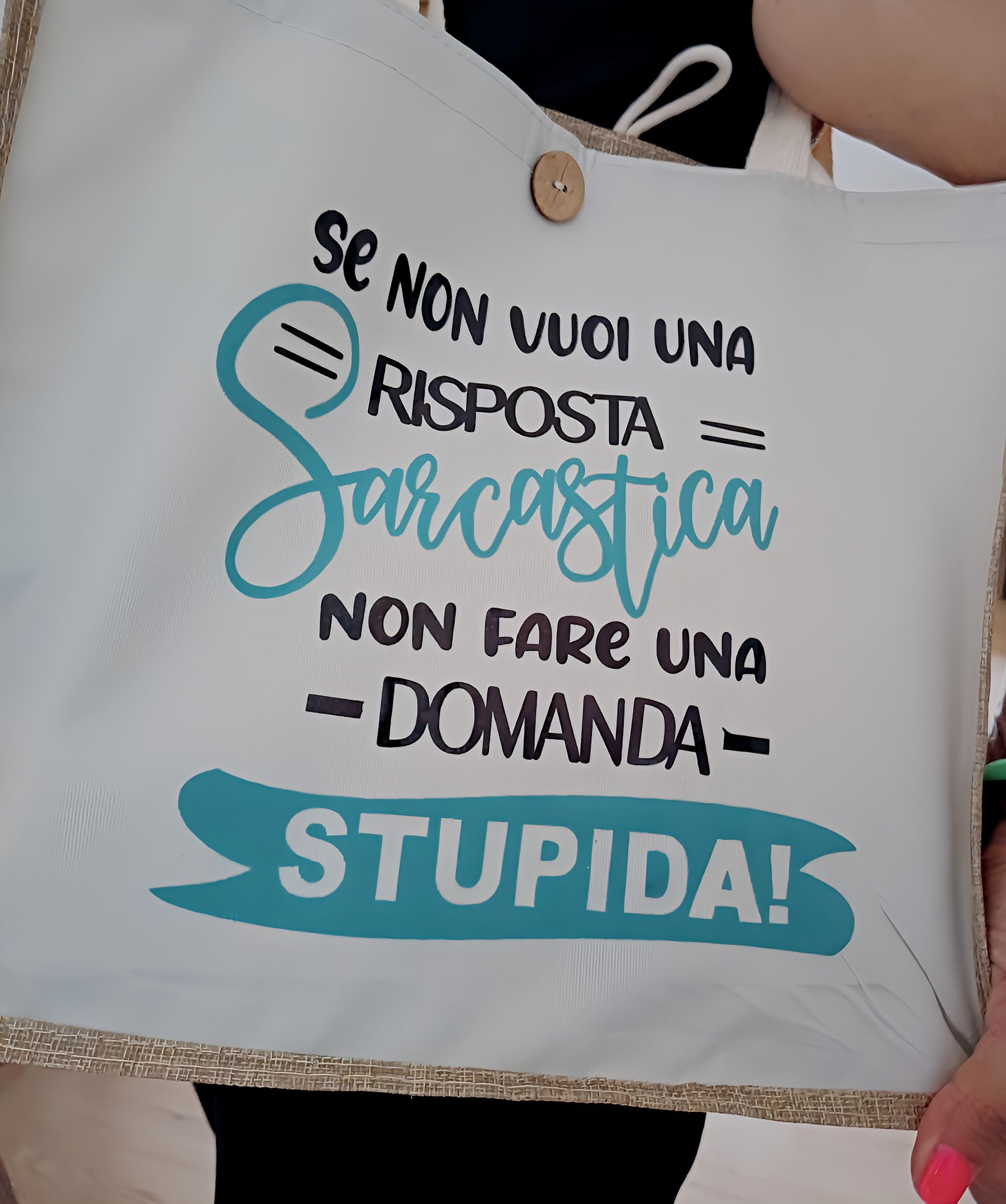 White tote bag with Italian sarcastic quote printed in black and turquoise lettering