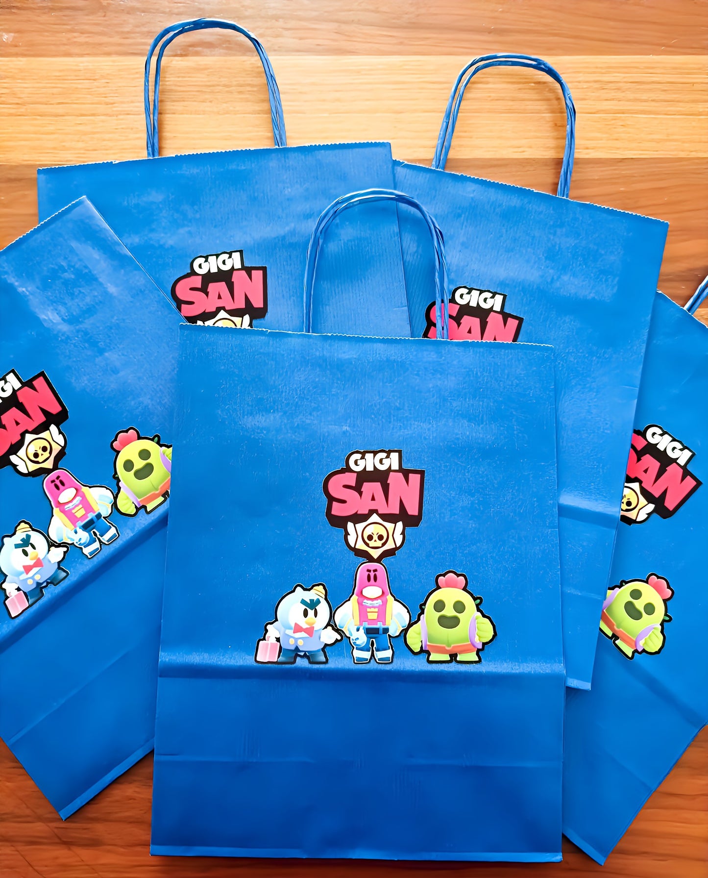 Blue Gigi San party bags with cartoon characters on wood background