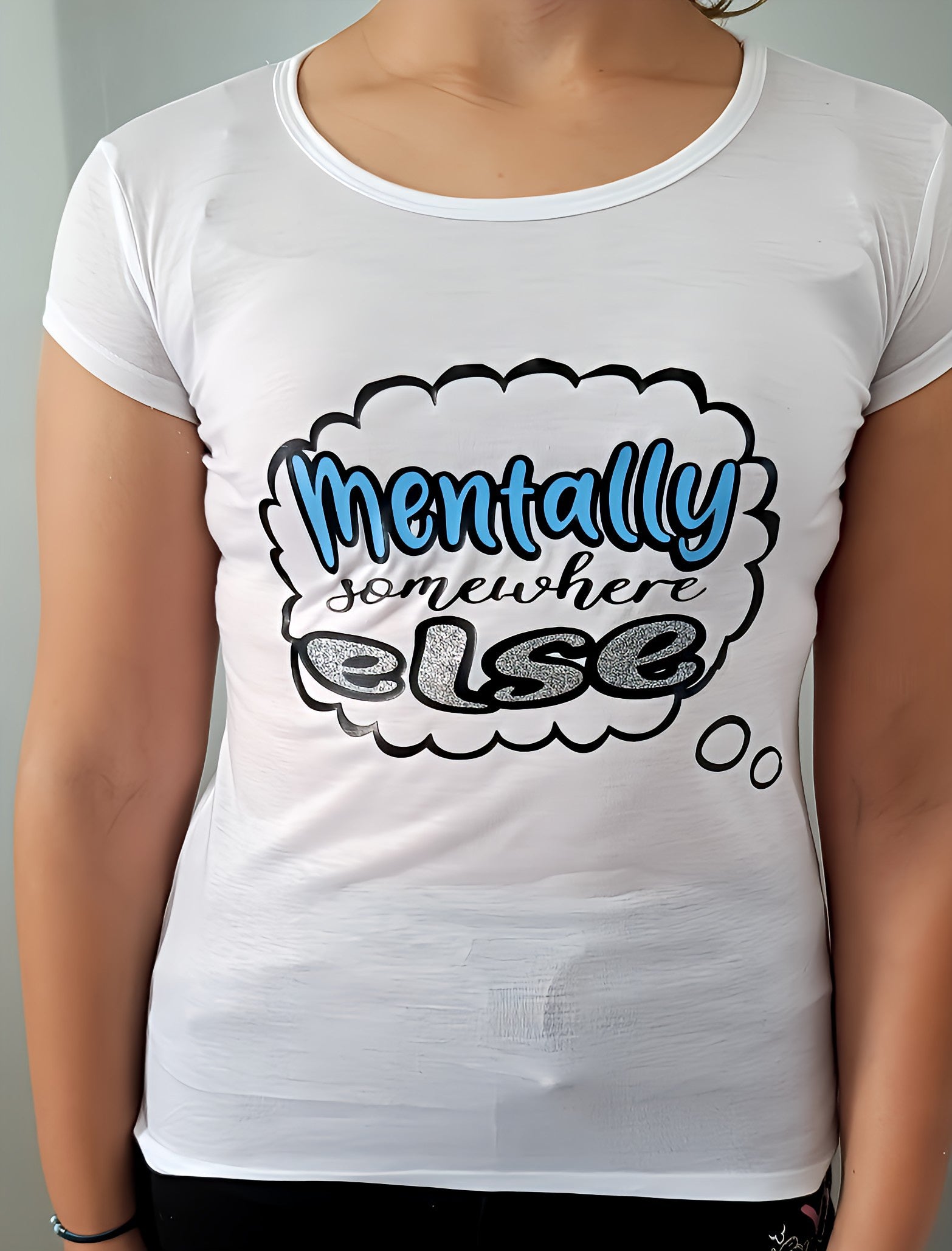 White t-shirt with 'Mentally somewhere else' slogan in bold comic-style text
