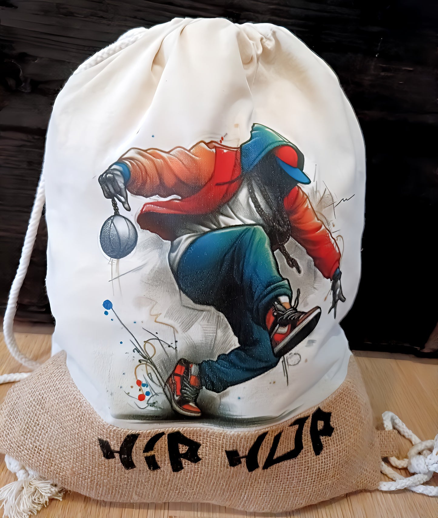 Hip hop drawstring bag with graffiti-style dancer illustration and 'hip hop' text on burlap base