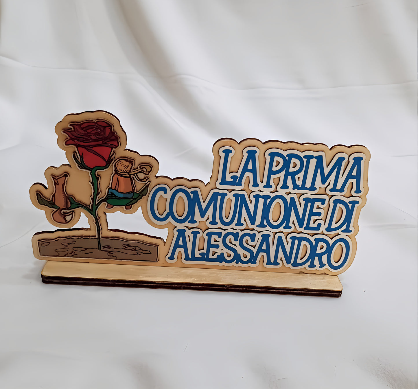 Wooden plaque for first communion with rose and Italian inscription on white background