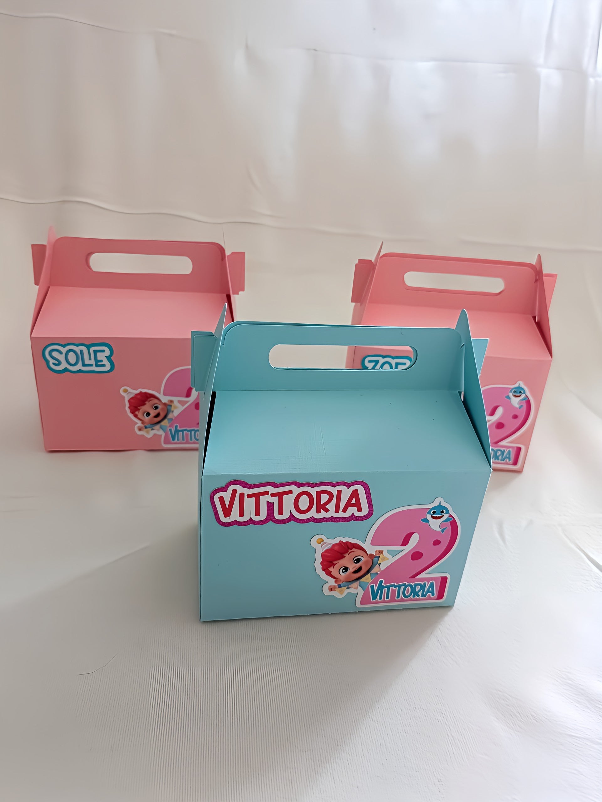 Colorful party favor boxes for kids named Vittoria, Sole, Zoe with cartoon characters and number 2