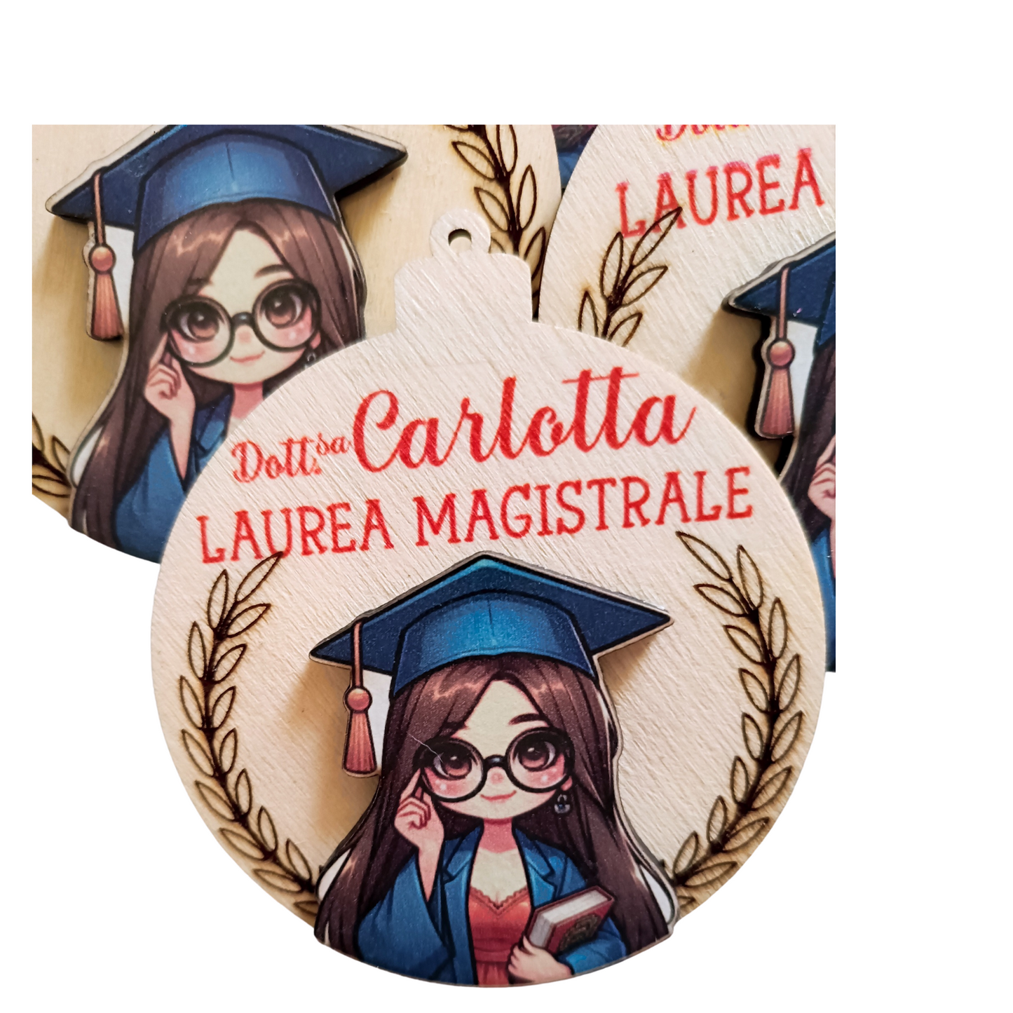 Wooden graduation ornament with cartoon girl in cap and gown, text Laurea Magistrale