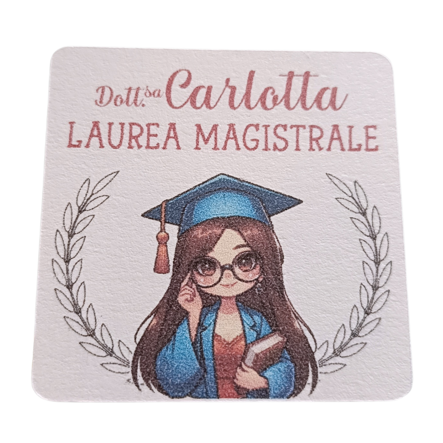 Cartoon girl in graduation gown and cap holding book, laurea magistrale text, laurel branches