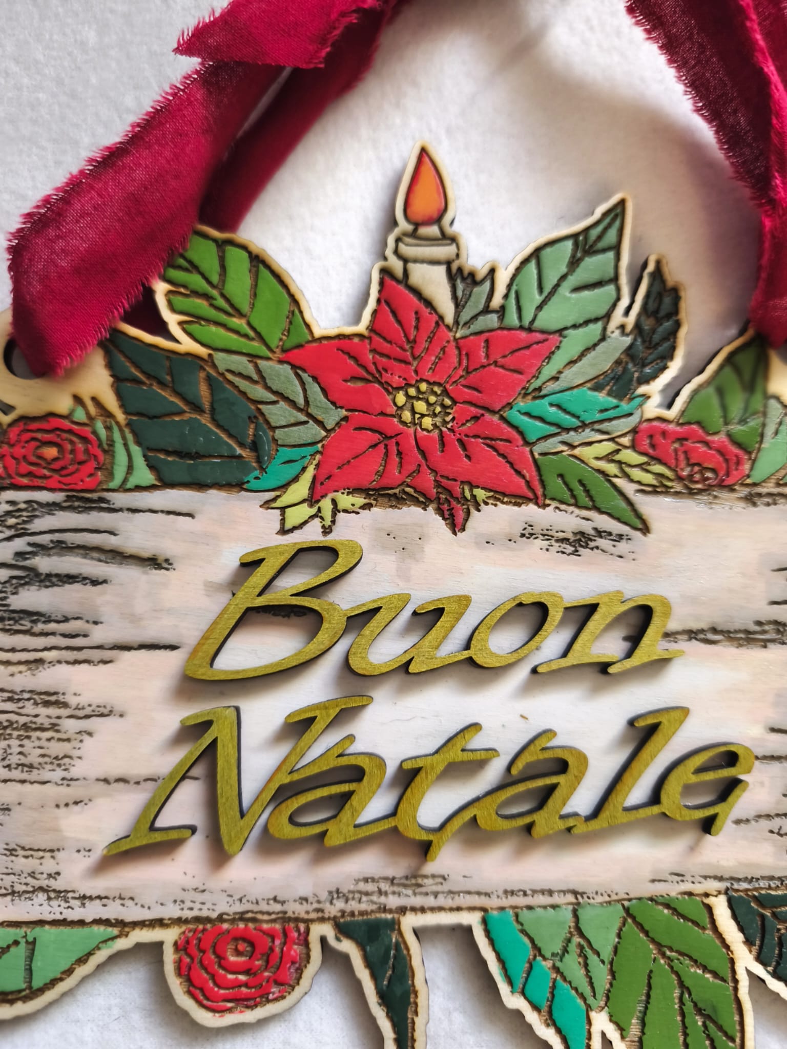 Wooden Buon Natale Christmas sign with poinsettia, candle, red fabric ribbon