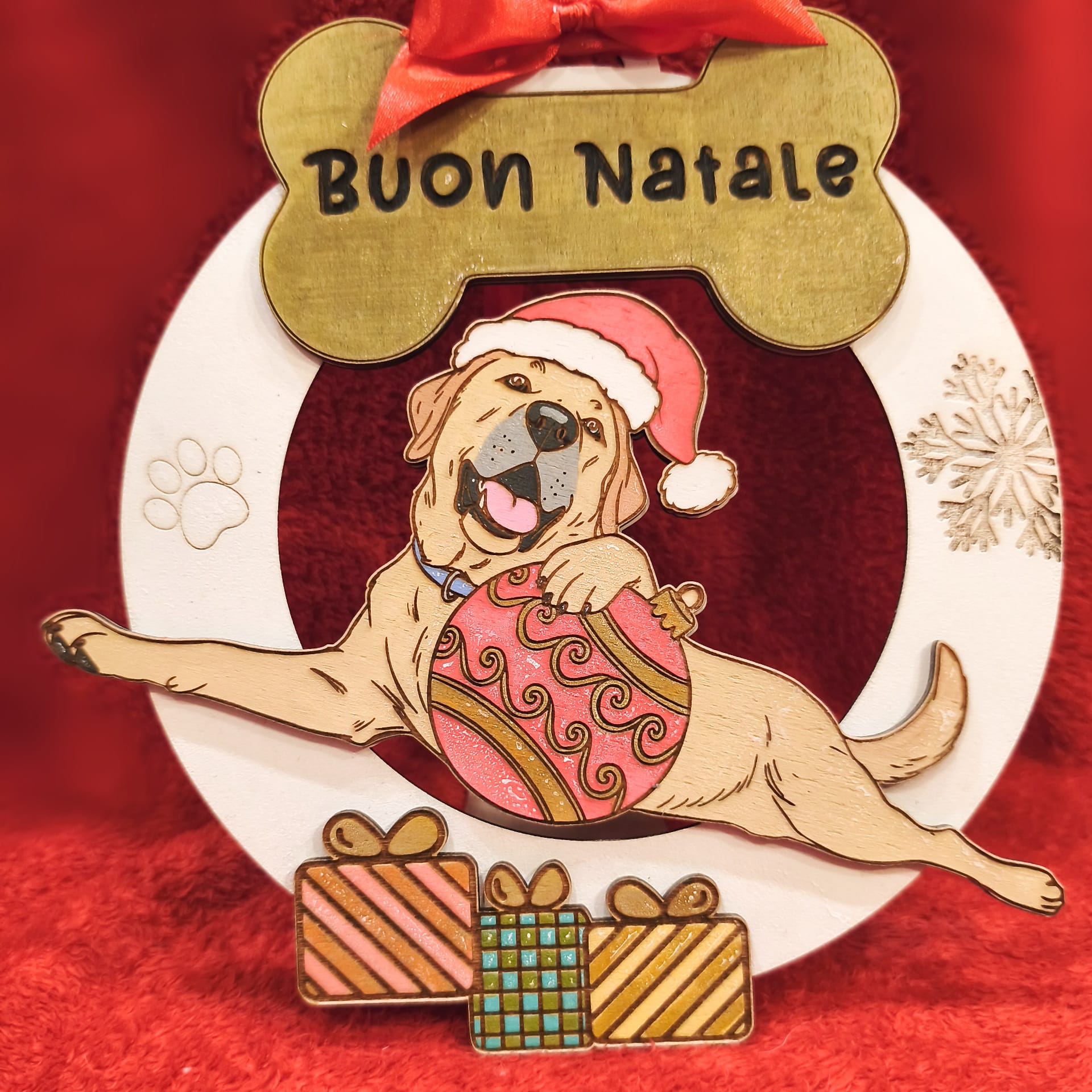 Christmas dog ornament with Santa hat, Buon Natale text, gifts, red background