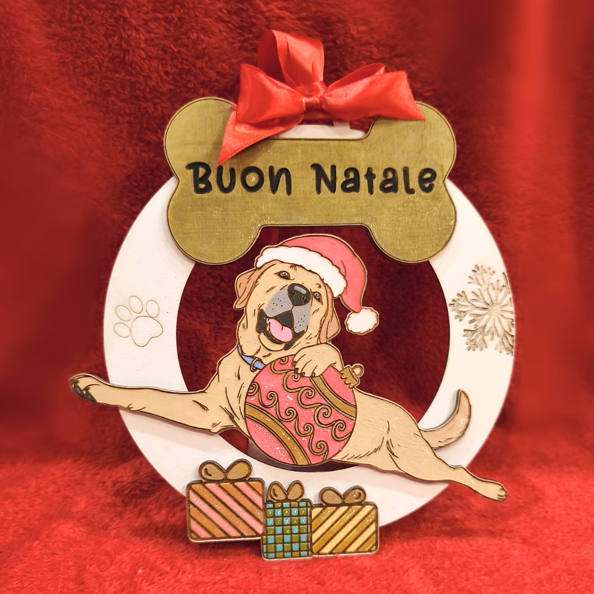 Dog Christmas ornament with 'Buon Natale', Santa hat, gifts, red background