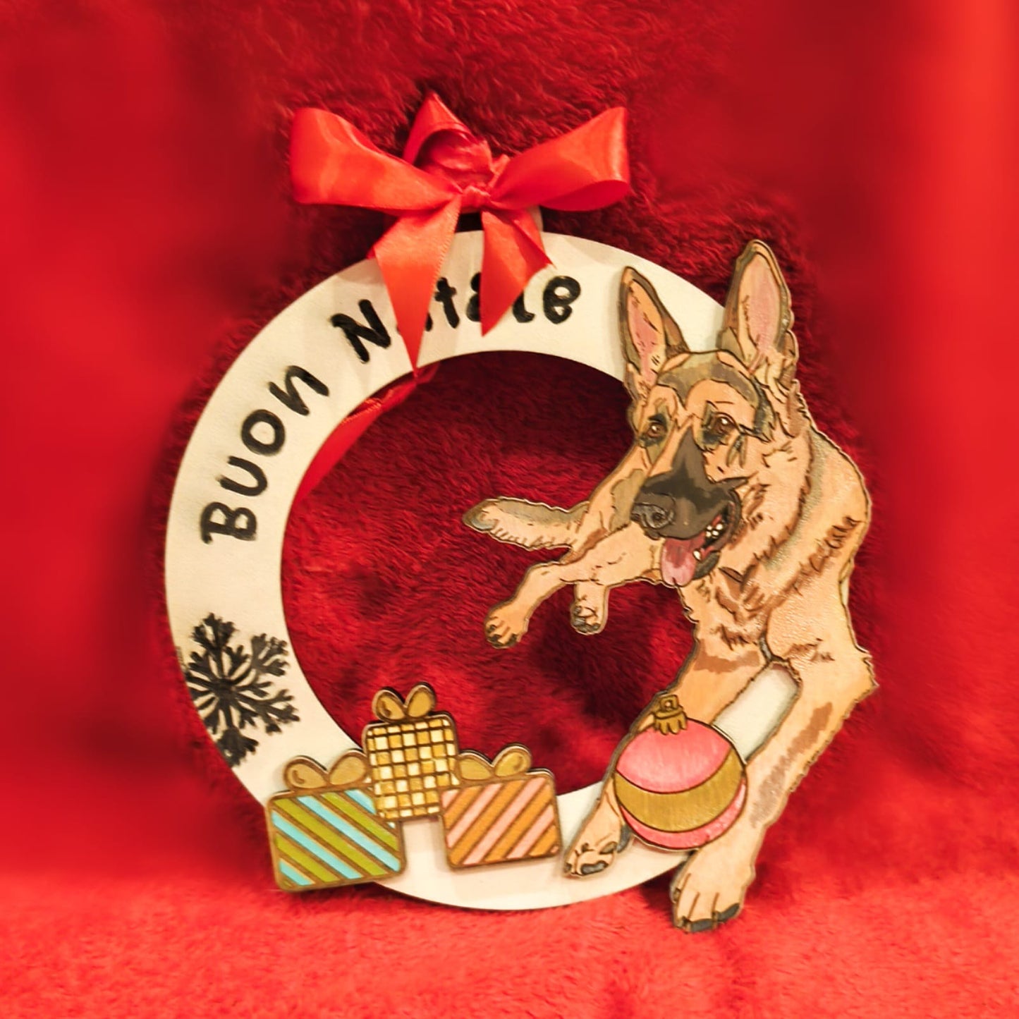 Christmas wreath with German Shepherd, gifts, red bow, Buon Natale text on red background