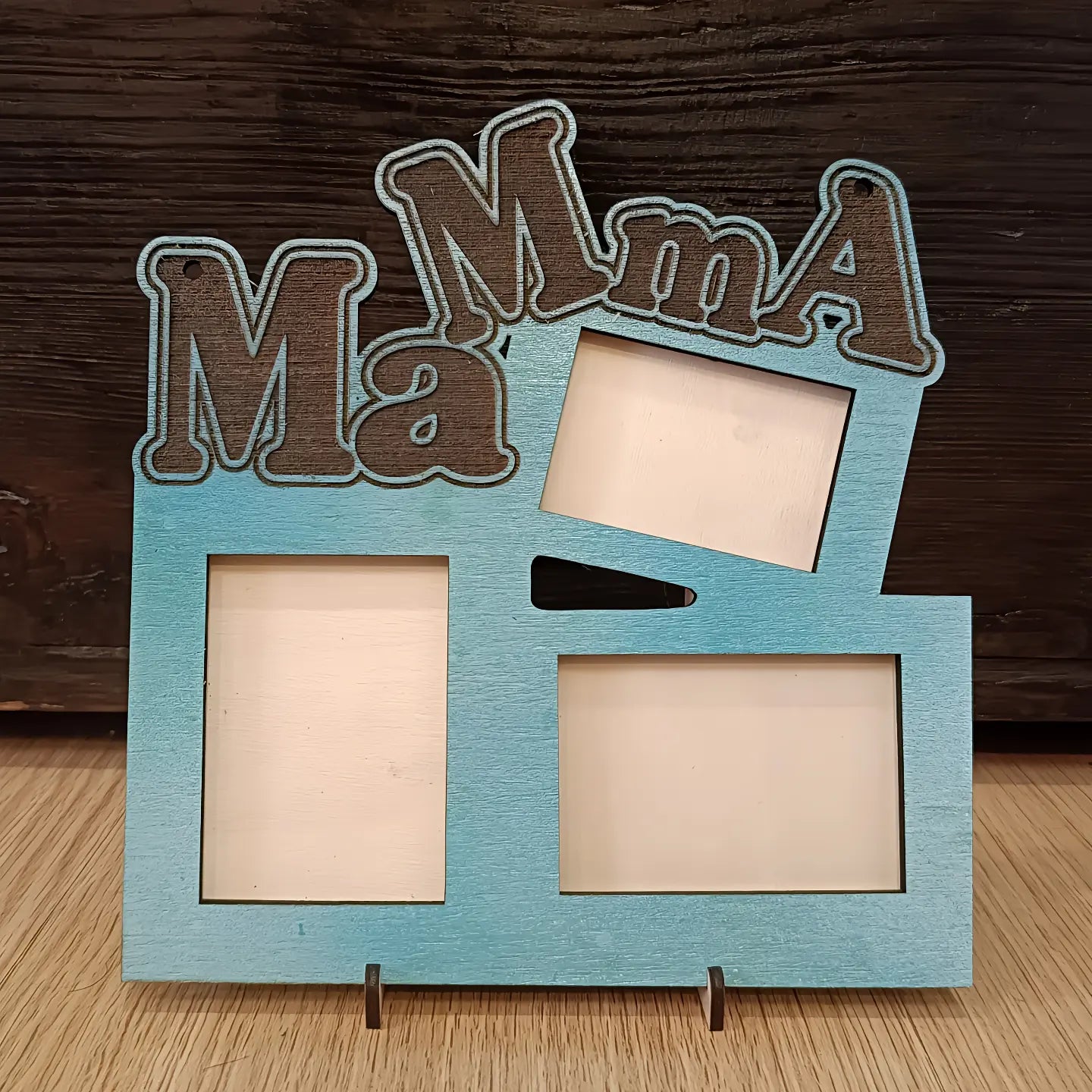 Blue wooden photo frame with 'Mama' text cutout, three empty picture slots on wood table
